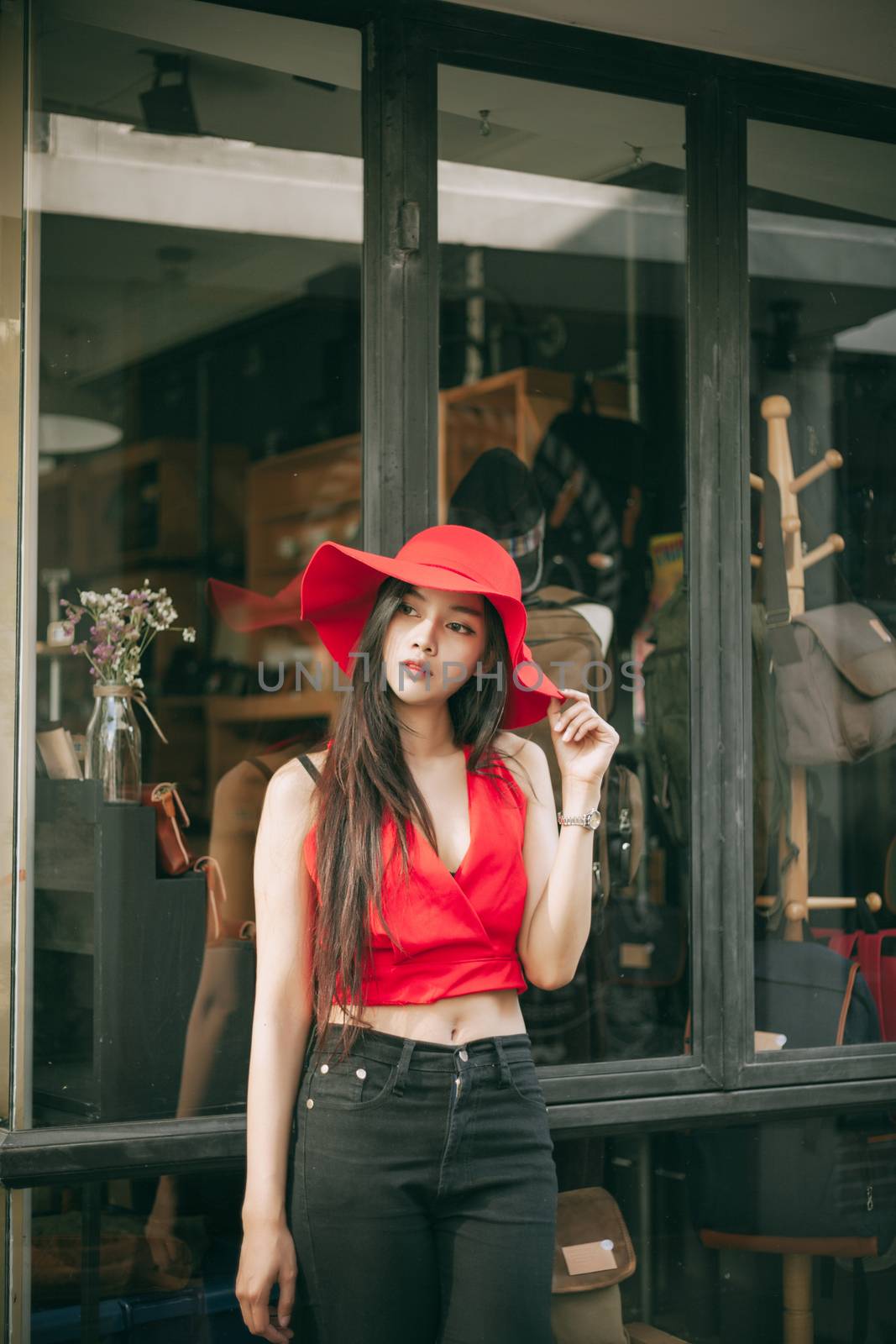 beautiful girl is posing with red suit and red hat.