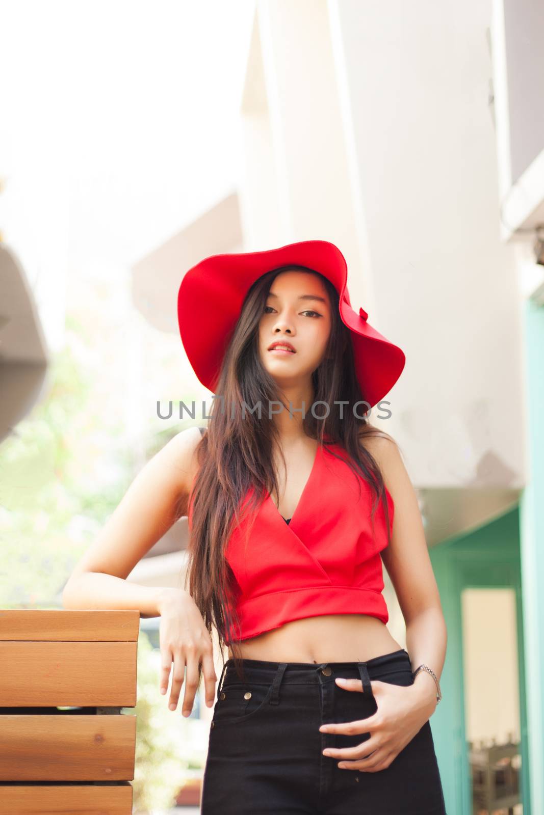 beautiful girl is posing with red suit and red hat.