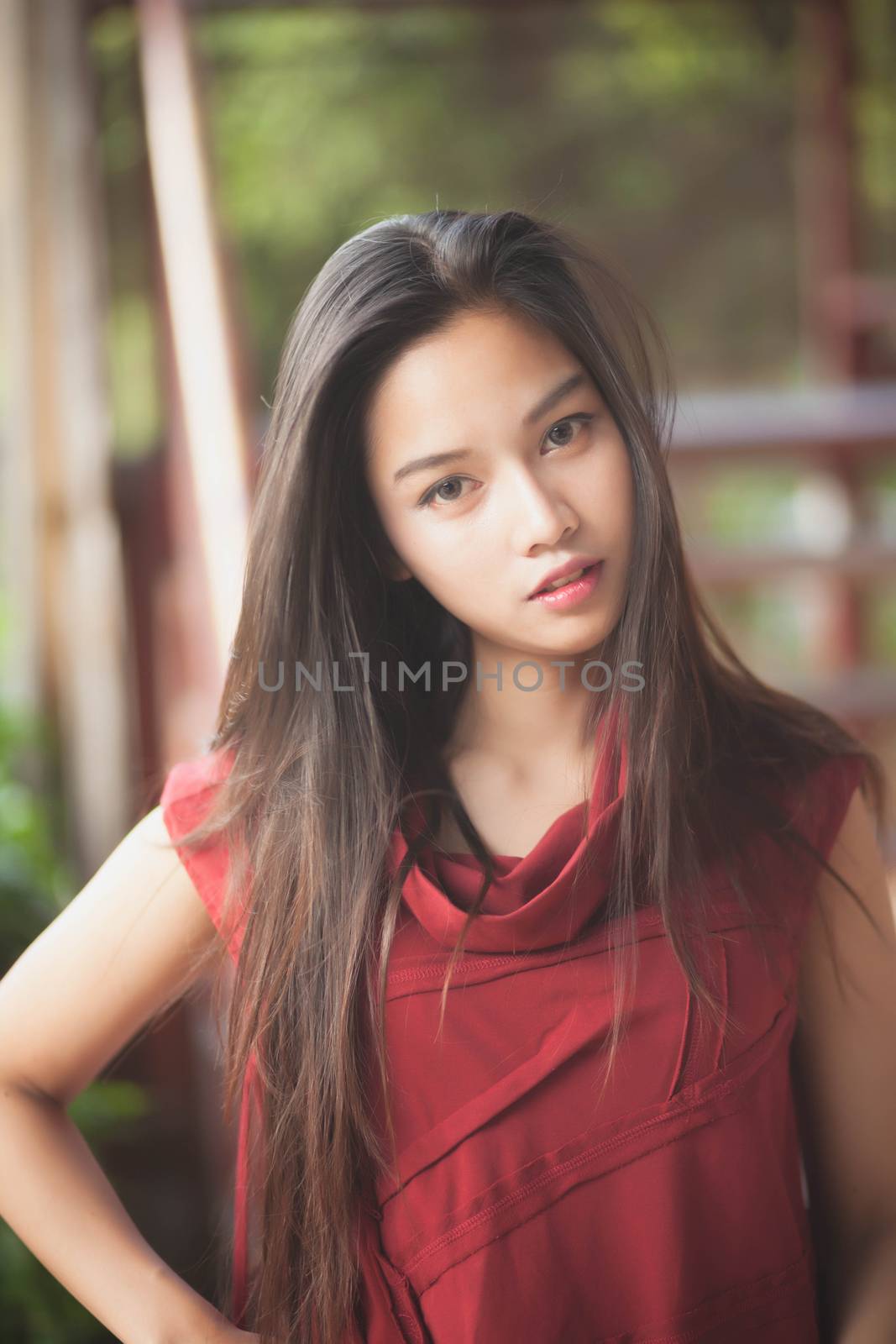 beautiful girl is posing with red suit.