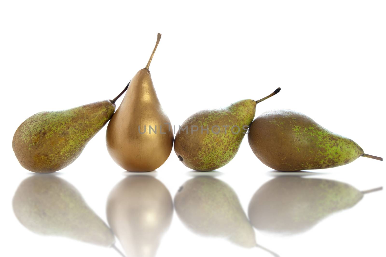 Golden pear standing out amongst row of fruit over a white background