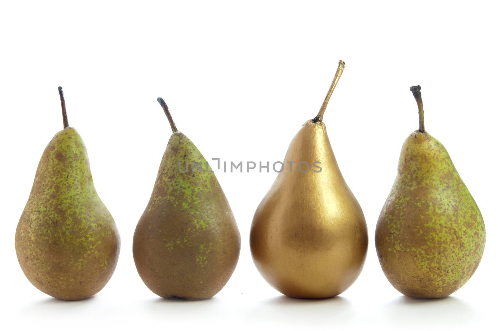 Unique gold pear standing out in a row of fruit over a white background