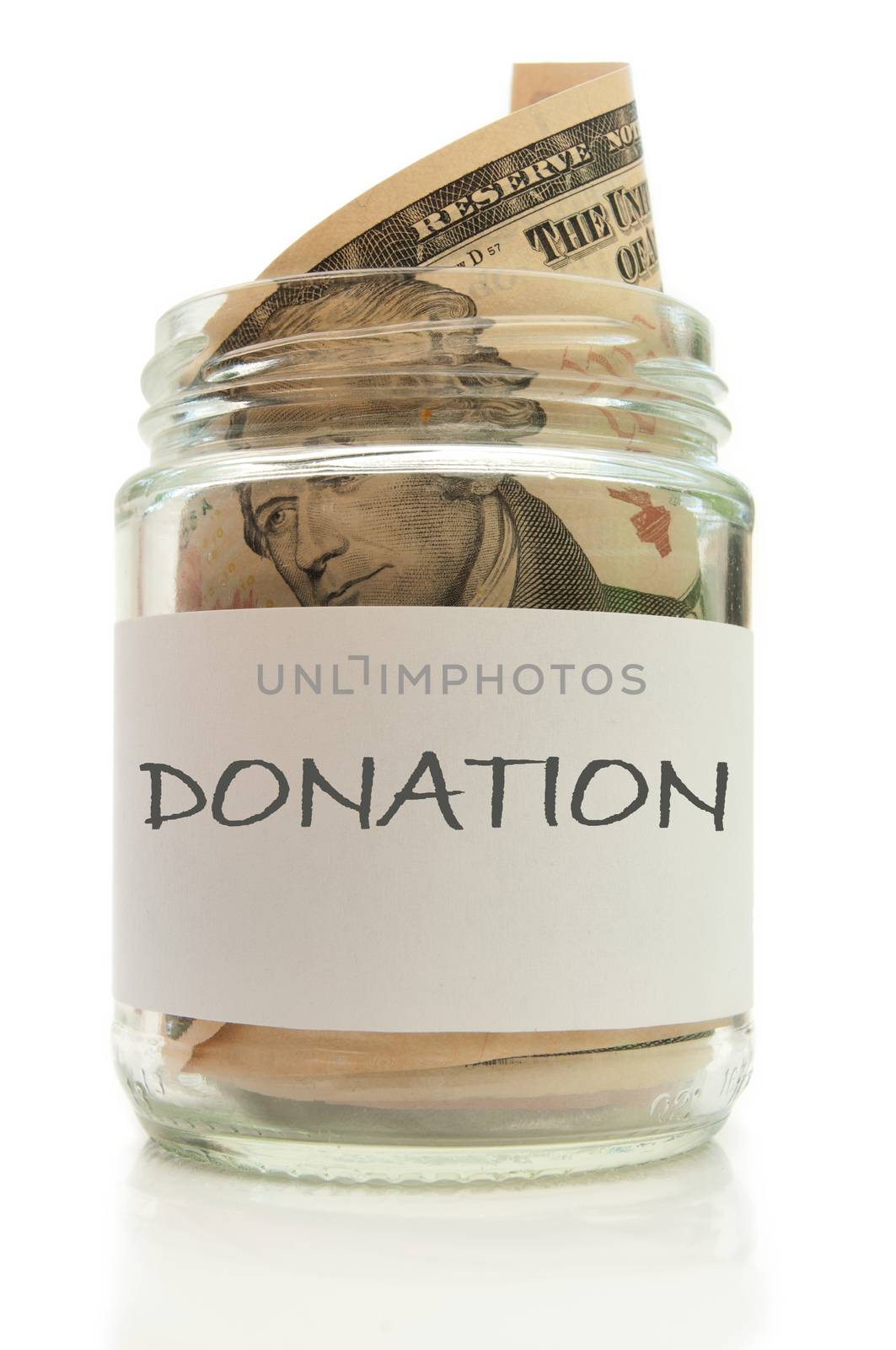 Glass jar filled with banknotes labeled with donation