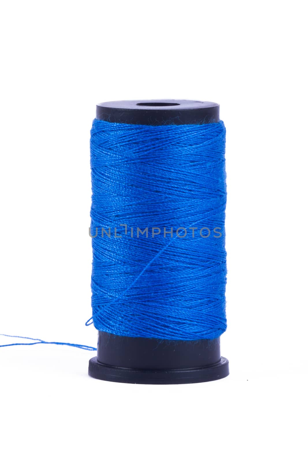 Blue standing sewing yarn, isolated on white background.