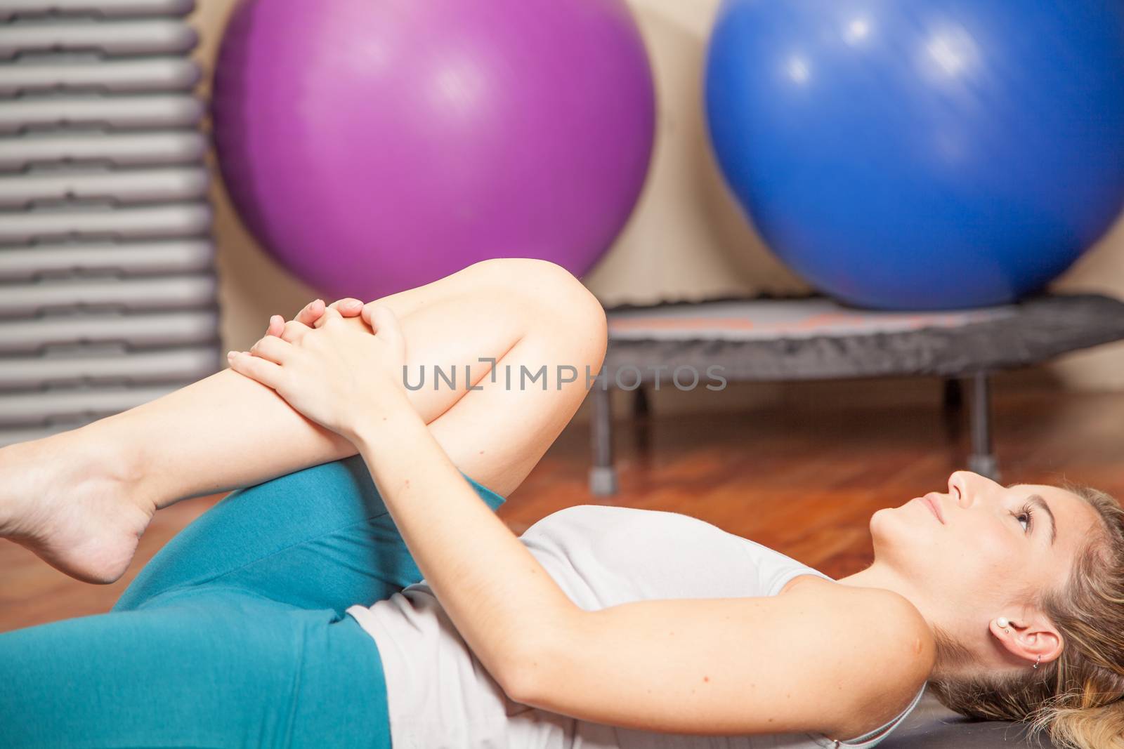 Woman lying doing yoga by ifilms
