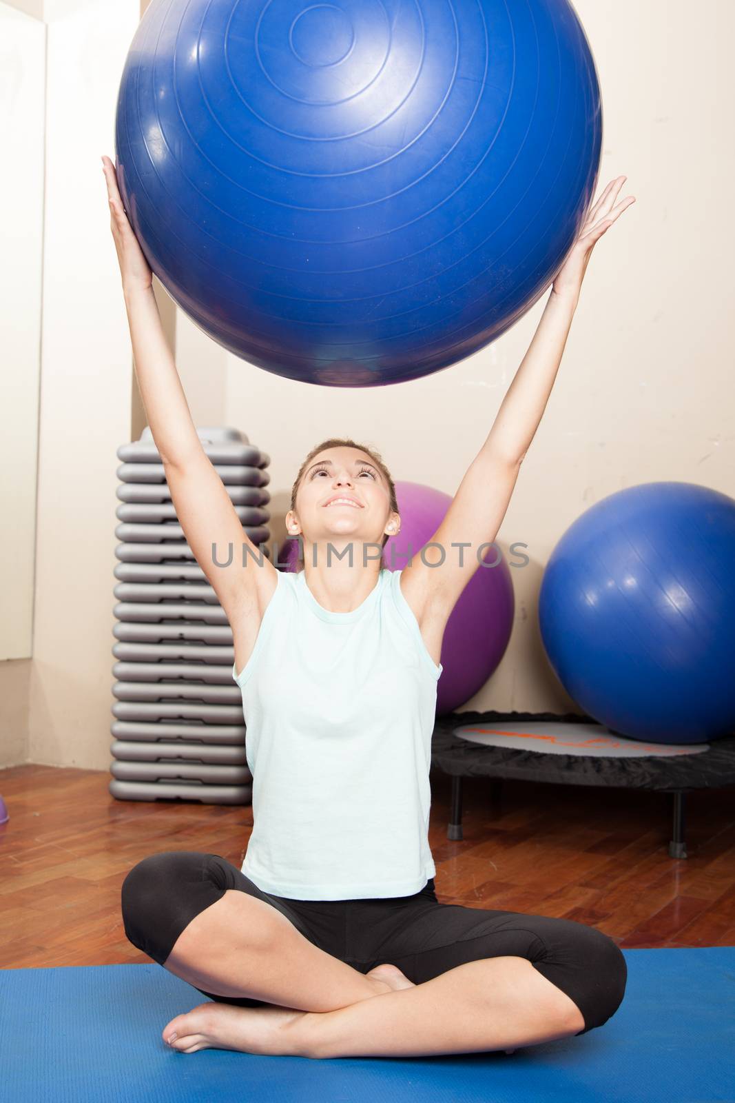 Woman stretching with a ball by ifilms