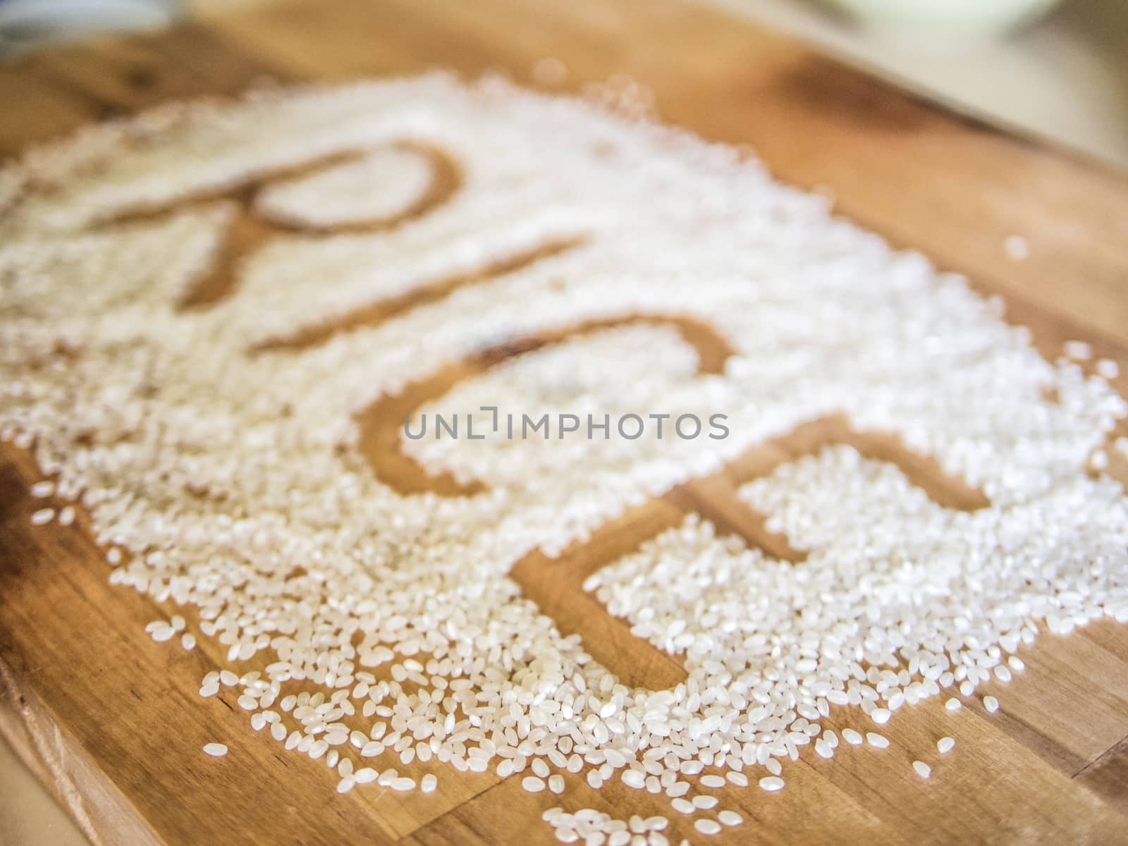 Rice word made of rice on wooden board