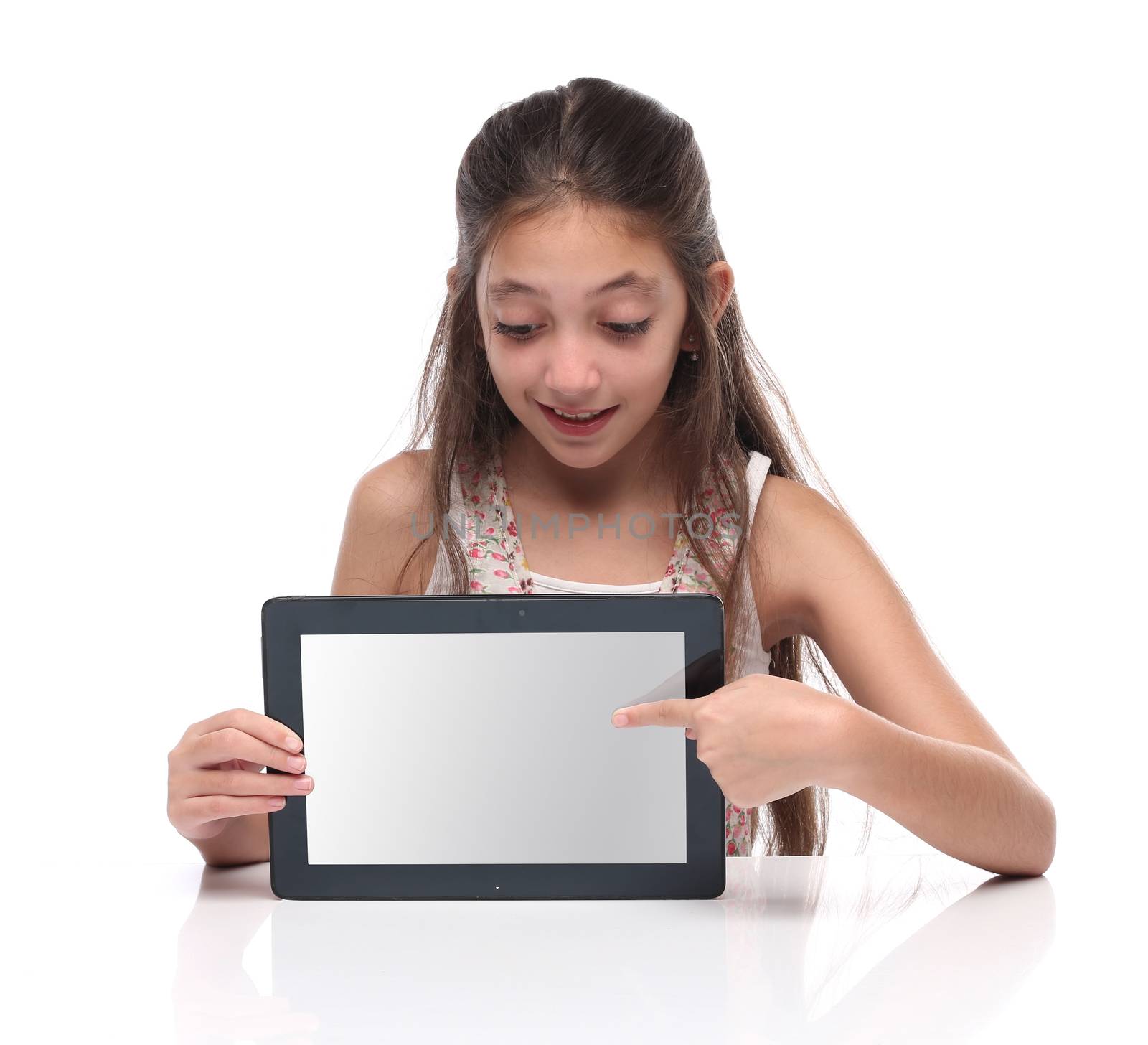 Beautiful pre-teen girl showing a tablet computer. Clipping path for the screen