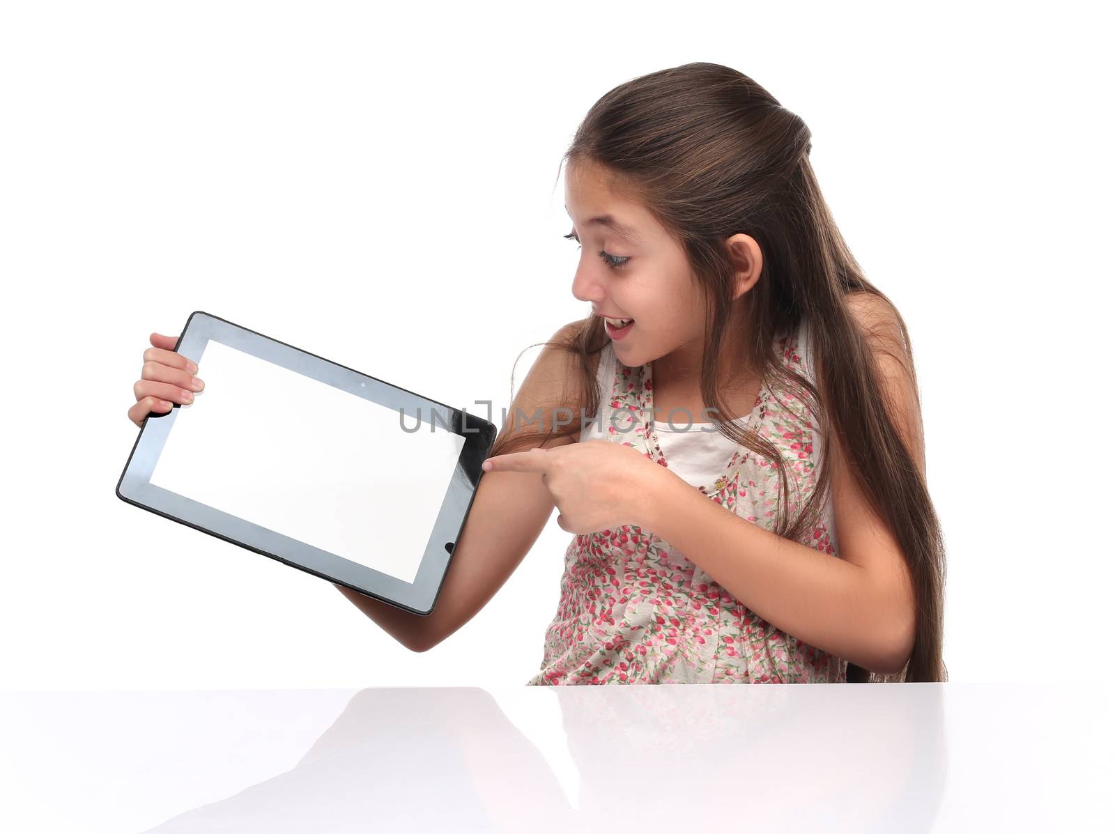 Beautiful pre-teen girl showing a tablet computer. by Erdosain