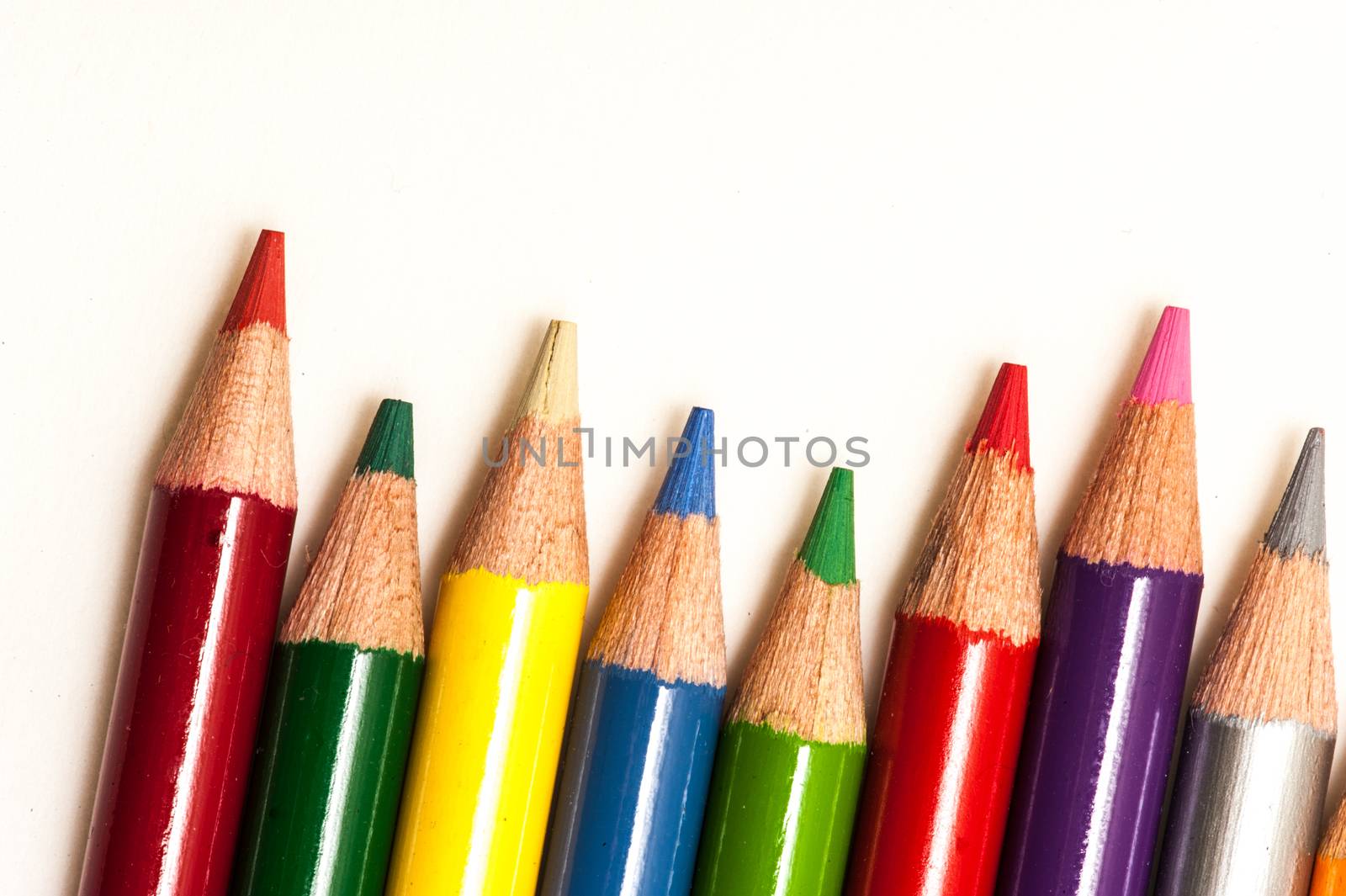 Many Colored pencils on a white background.