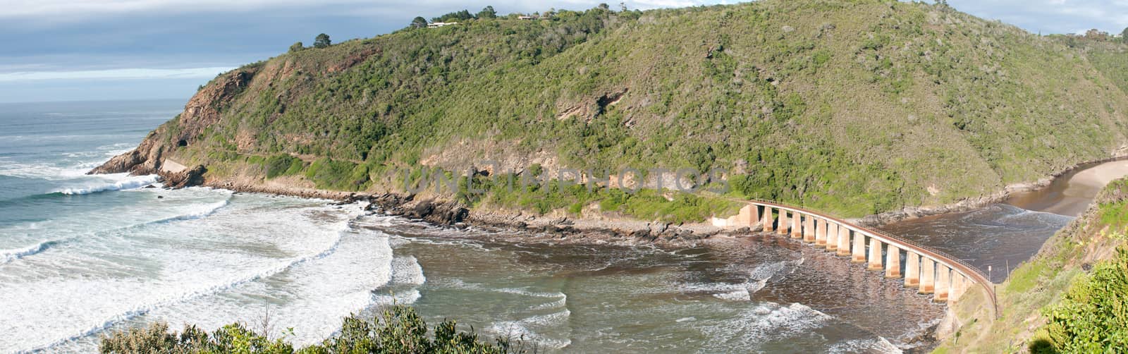 GEORGE, SOUTH AFRICA - JANUARY 5, 2015: Historic railway bridge over the Kaaimans River between George and Wilderness. The tunnel is also visible