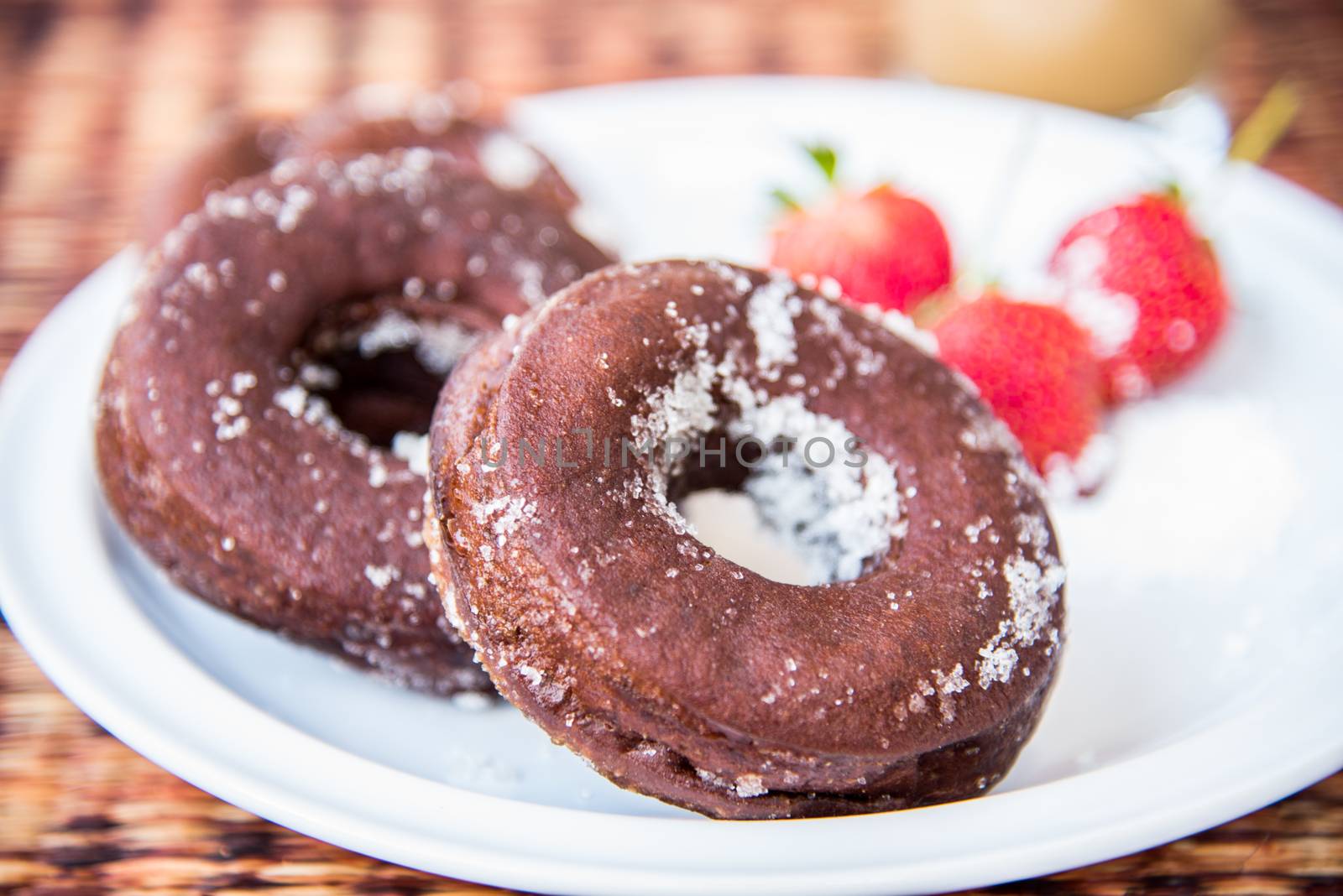 Sugar chocolate donuts and fresh strawberries and ice coffee