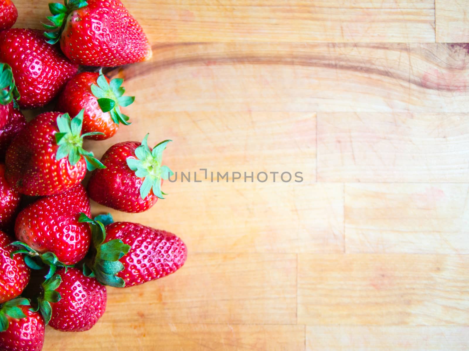 Strawberries on a wooden board with empty space by weruskak