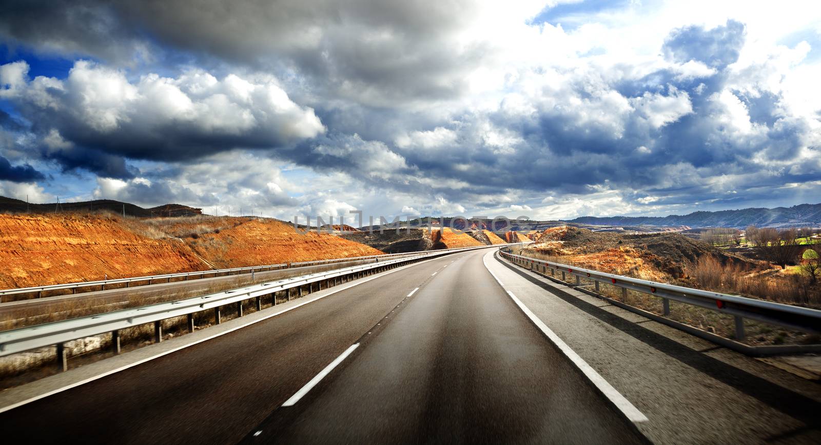 Road scenery. Travel concept.Cloudy sky and high road 
