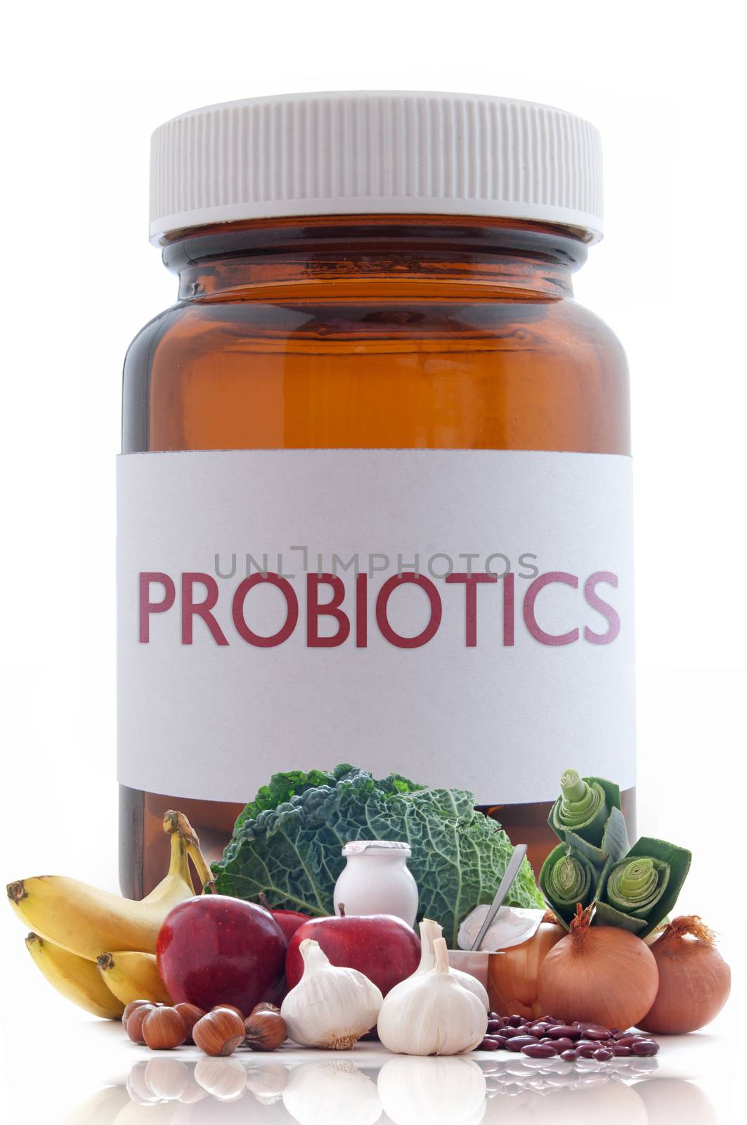 Probiotic (or prebiotic) rich foods with a medicine pill jar in the background 