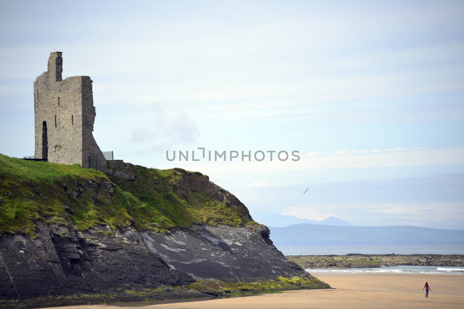 ballybunion castle on the cliffs of a beautiful beach by morrbyte