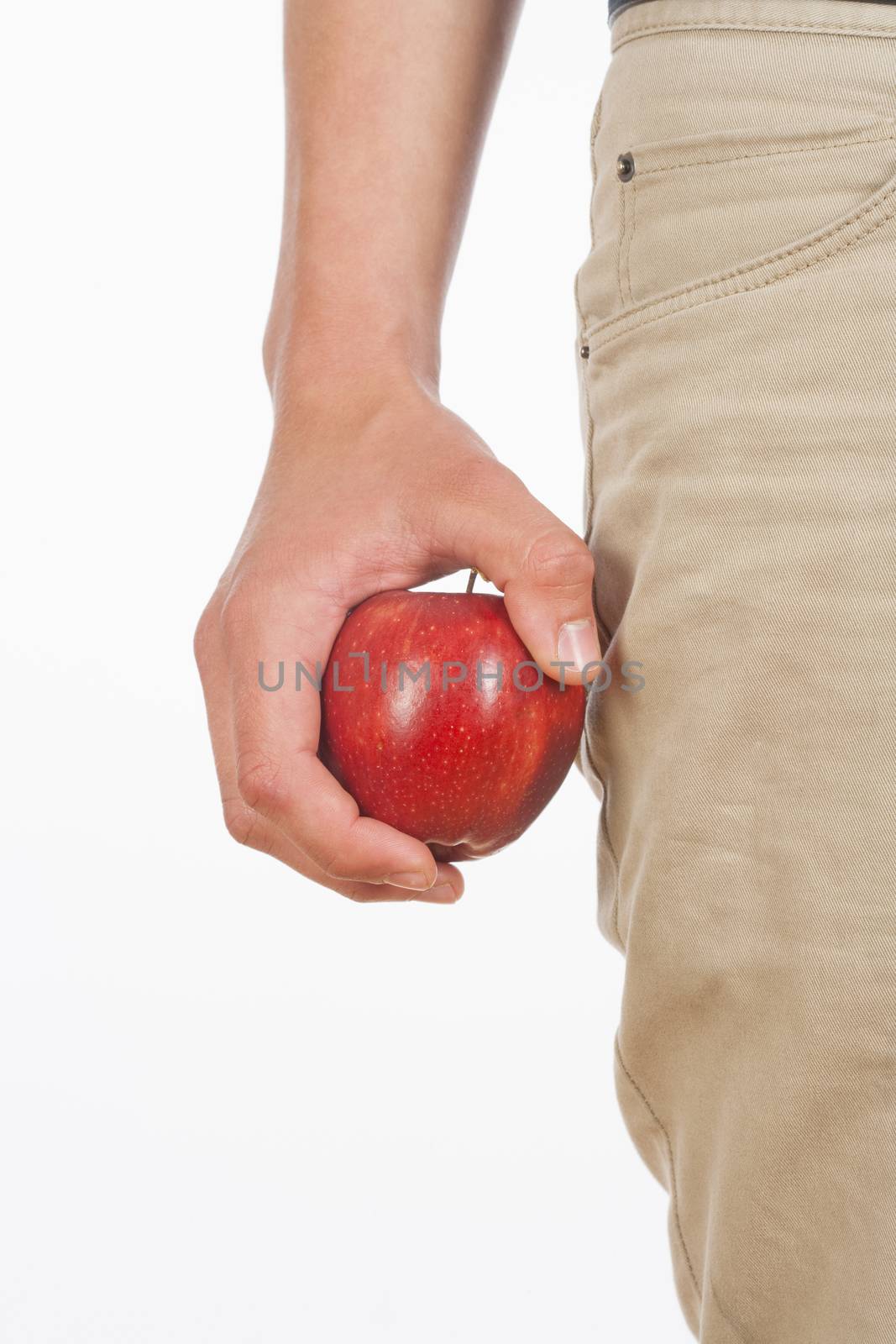Hand Holding Red Apple Against White Background by courtyardpix