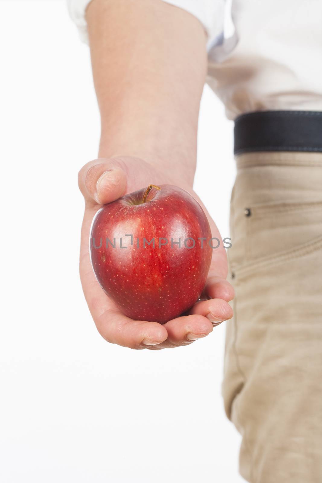 Hand Holding Red Apple Against White Background by courtyardpix
