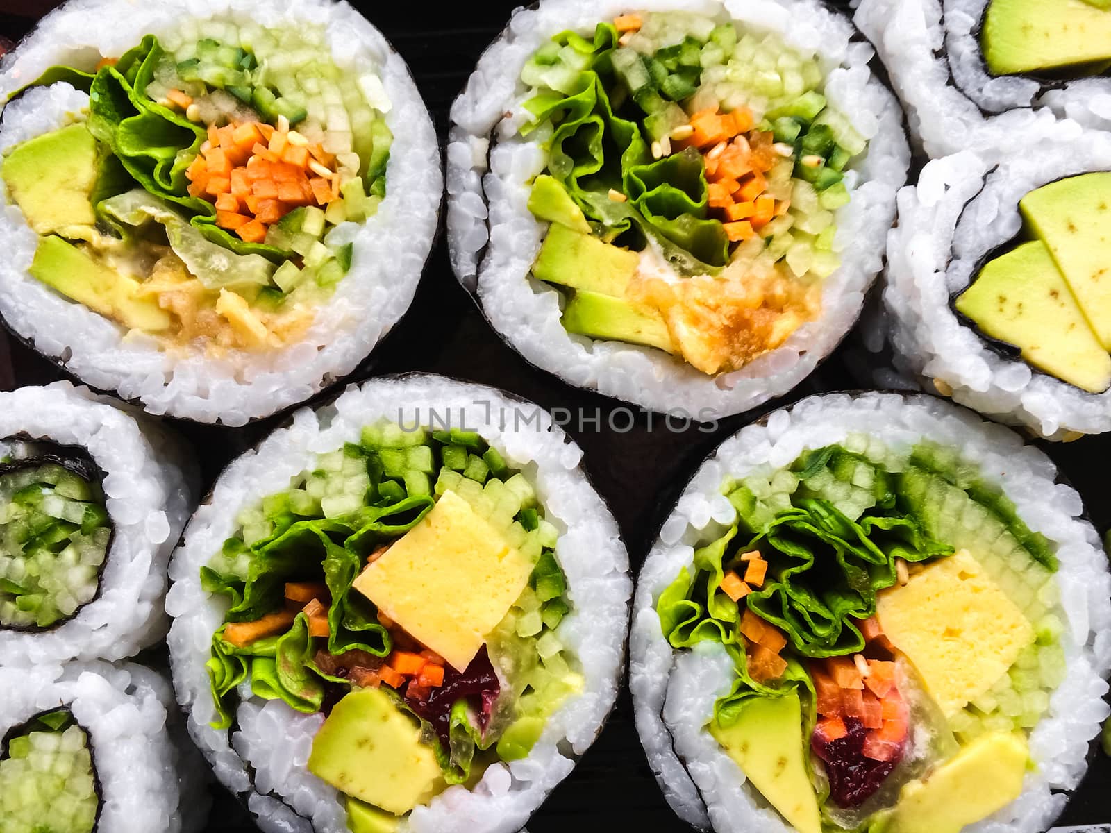 Close-up of vegetarian sushi on dark background.