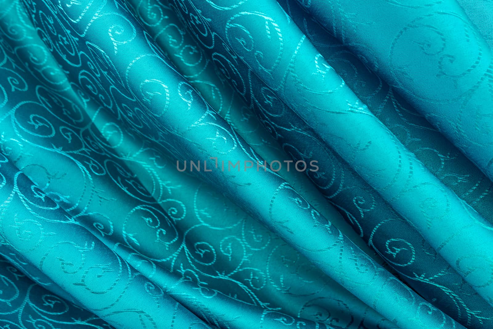 Light blue silk curtain with motifs.