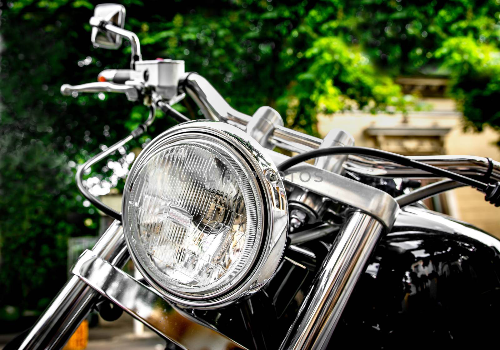 Vintage black motorbike with round headlight.