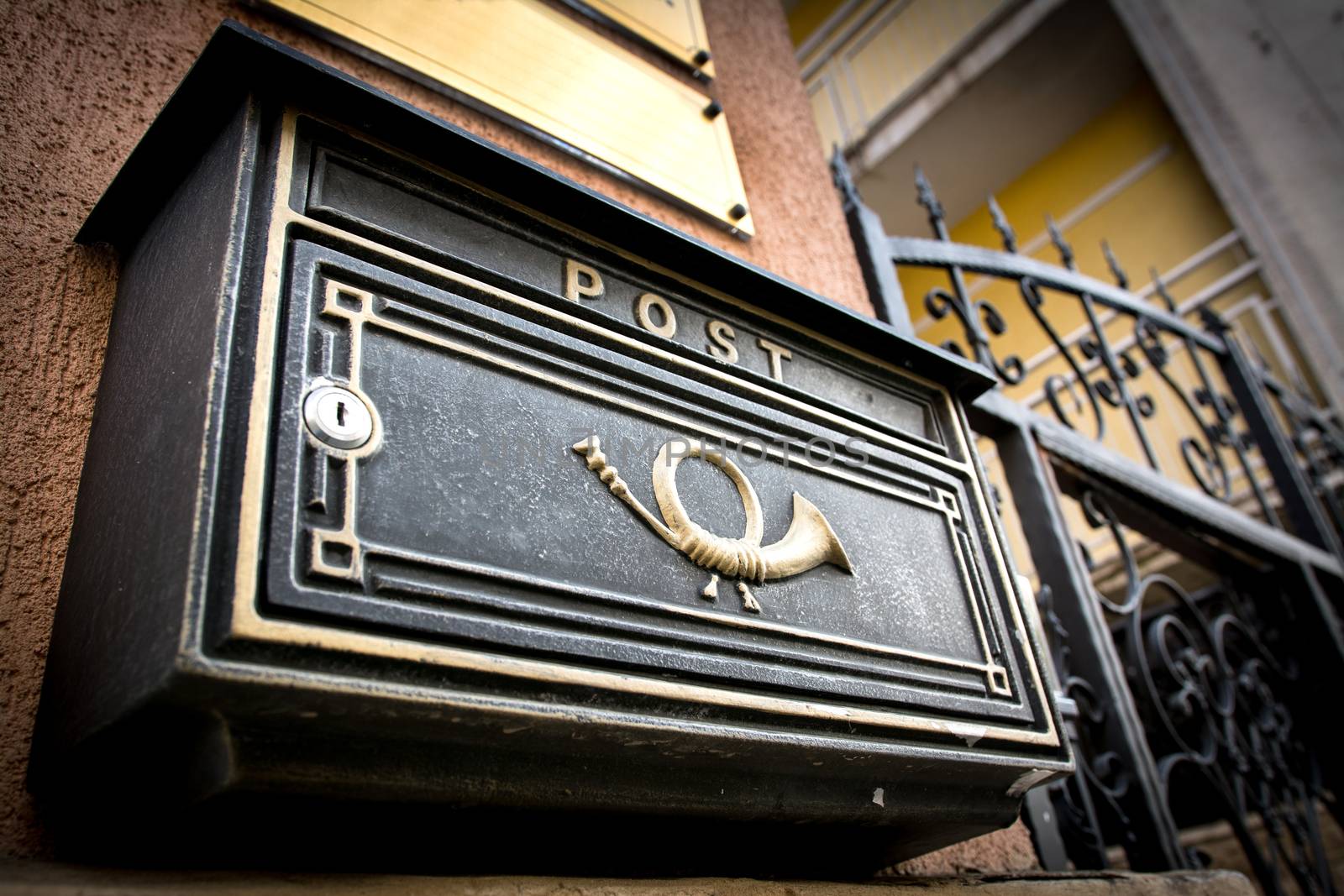 Black vintage mailbox with post written on it.