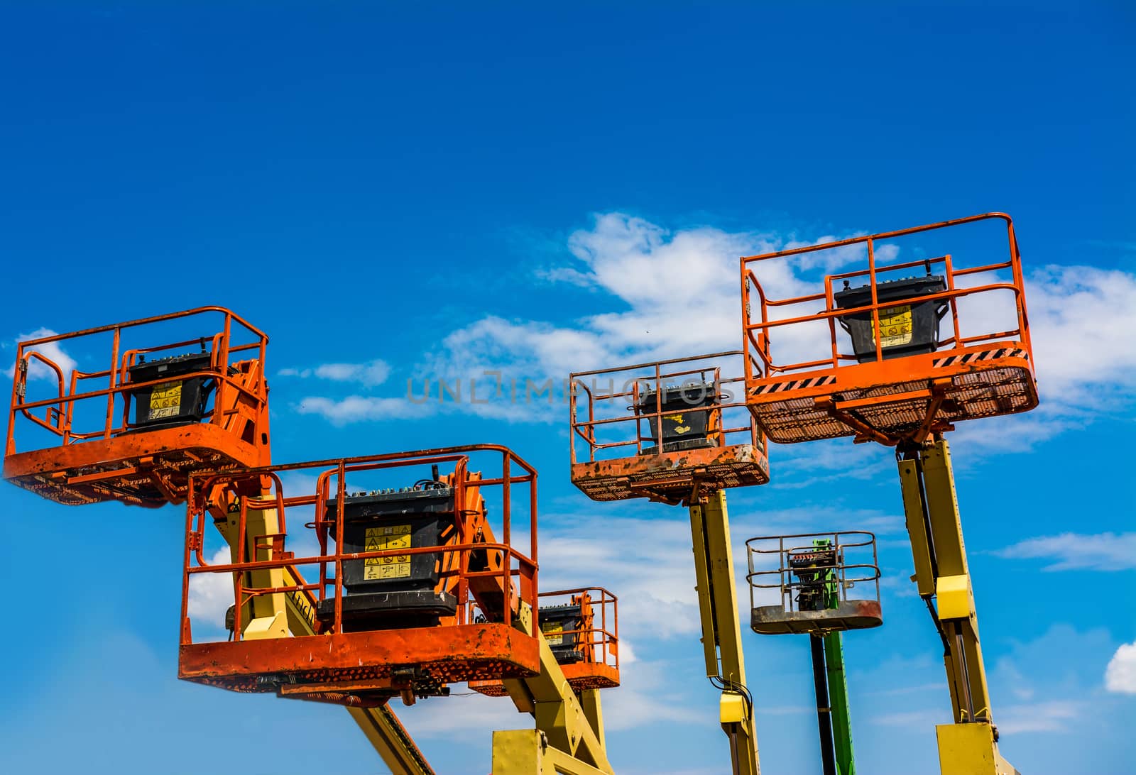 Orange industrial man lifting cranes.