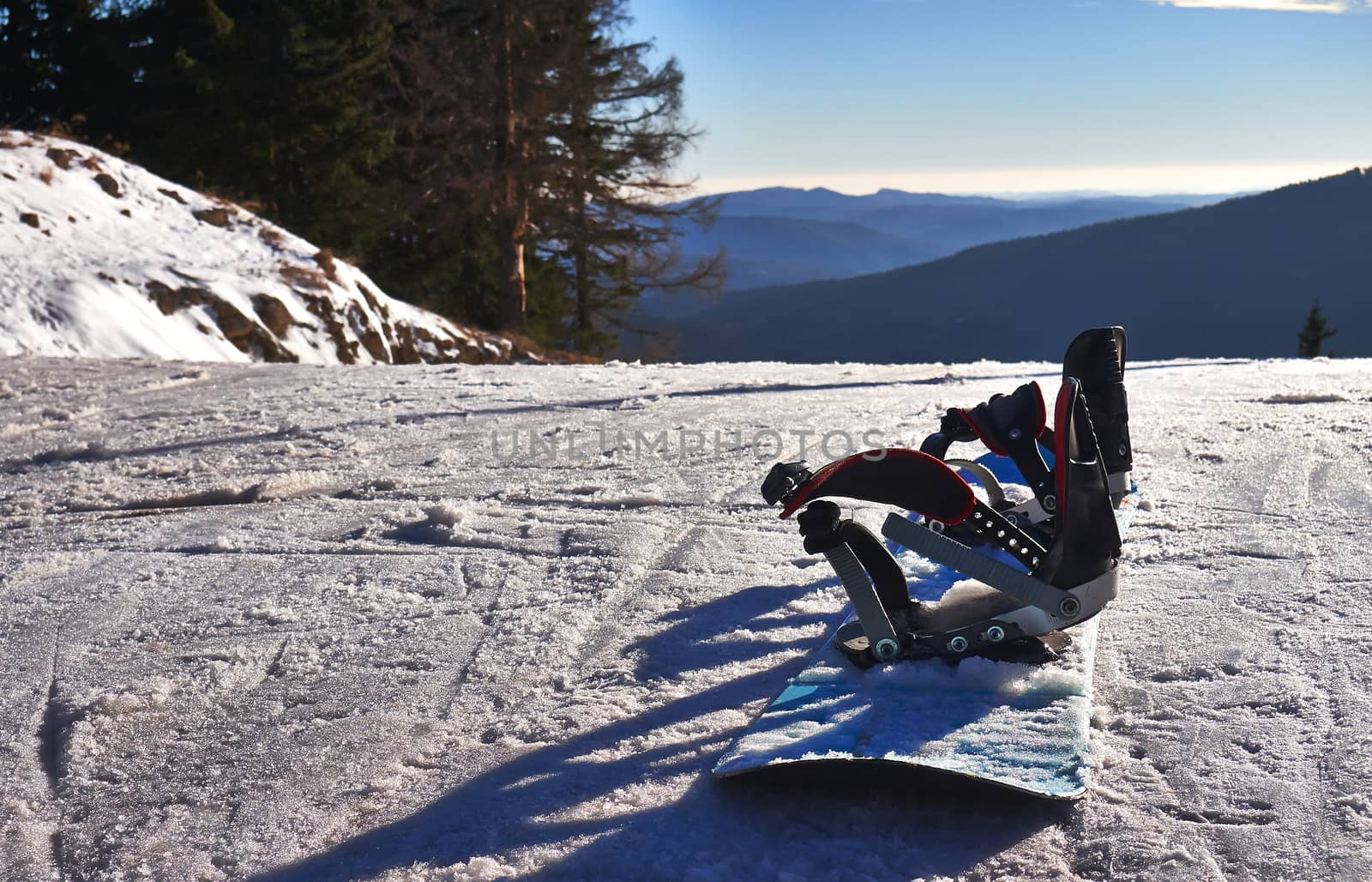 Winter sports. Snowboard on snow ski slope.   