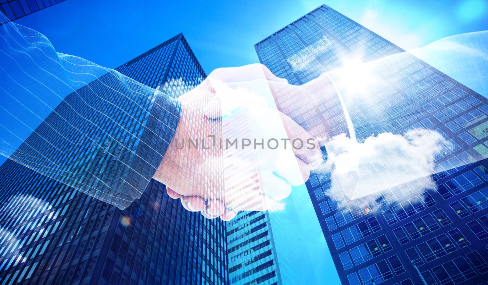 Business people shaking hands against skyscraper