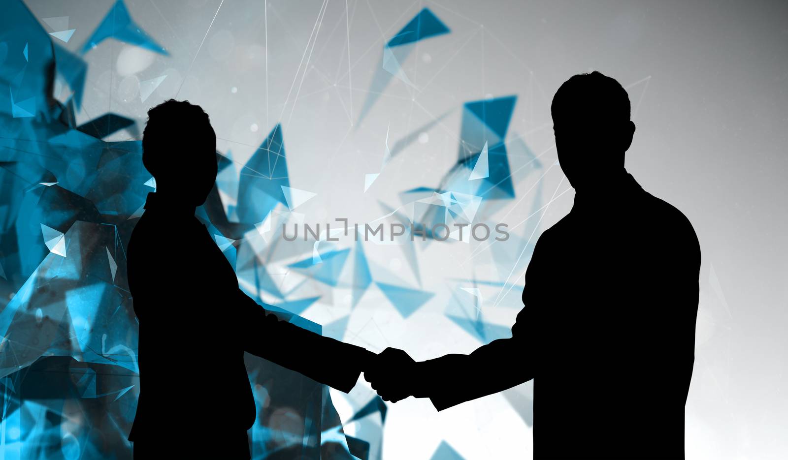 Composite image of smiling business people shaking hands while looking at the camera by Wavebreakmedia