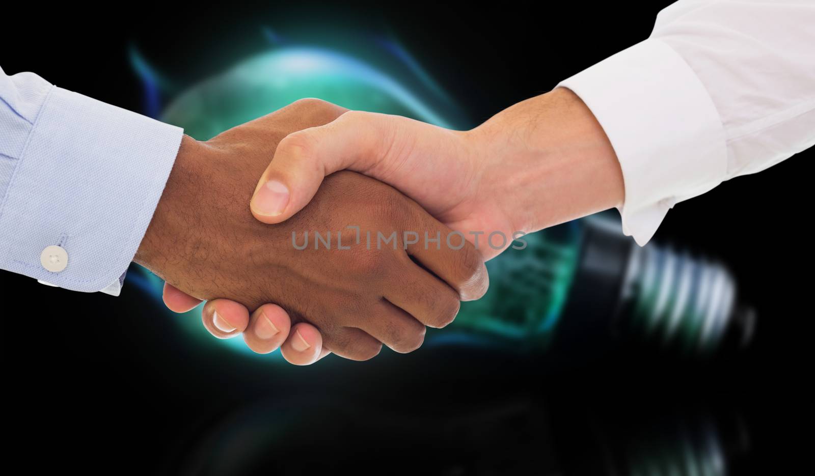 Composite image of close-up shot of a handshake in office by Wavebreakmedia