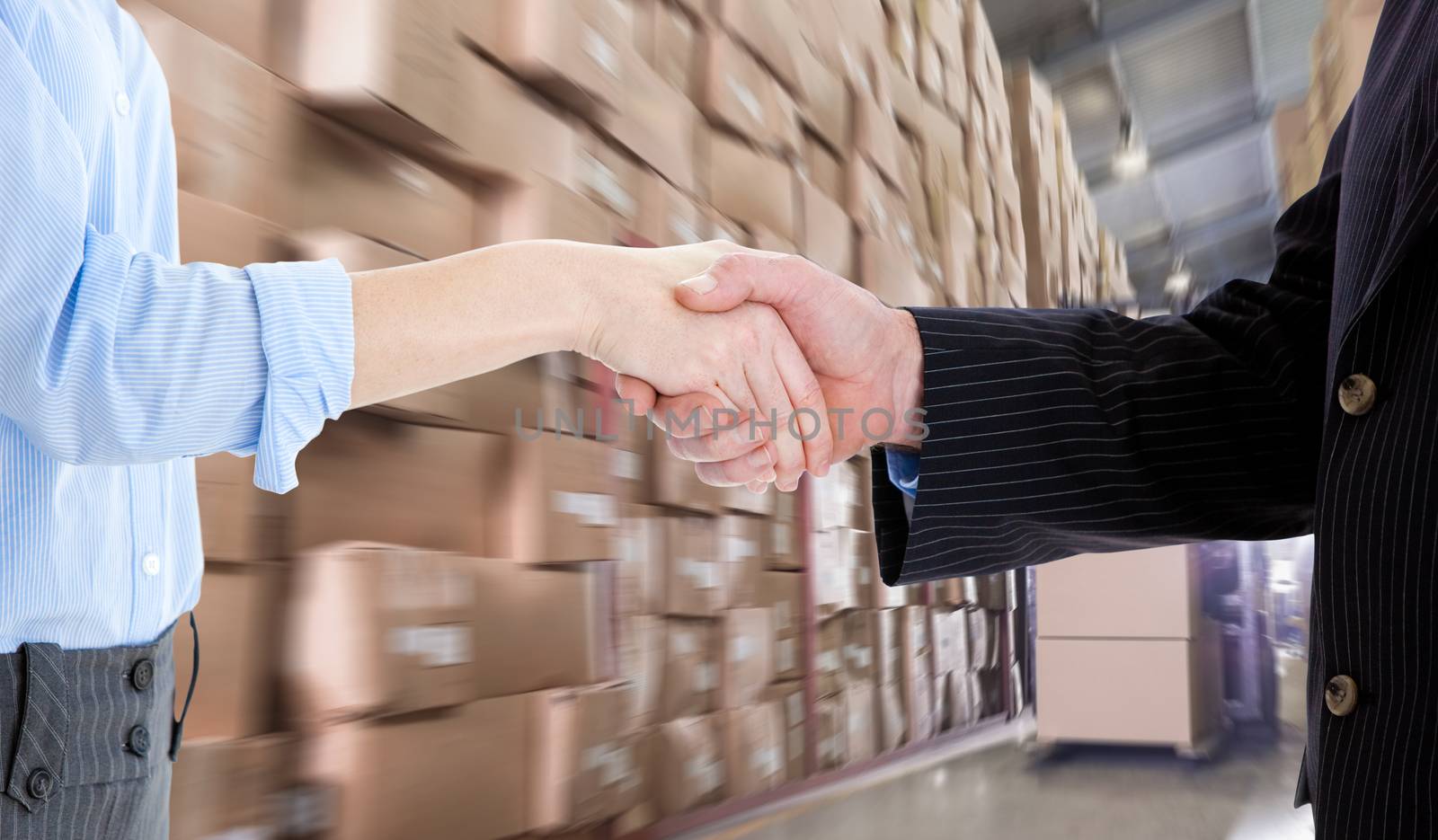 Close up of a business people closing a deal  against forklift machine in warehouse