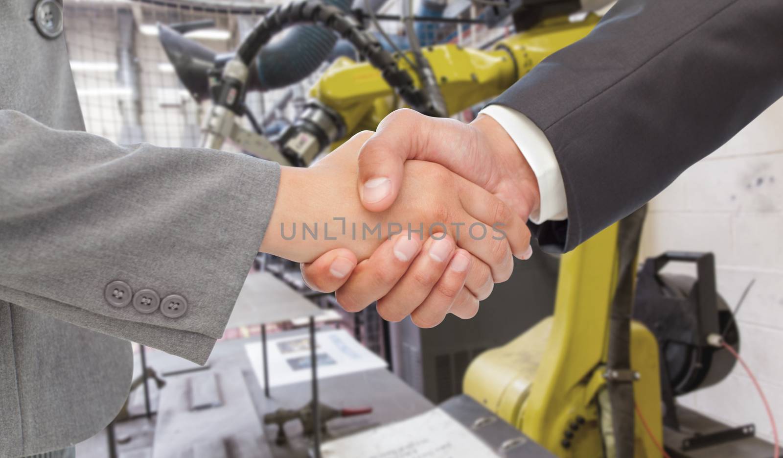 Handshake between two business people against garage