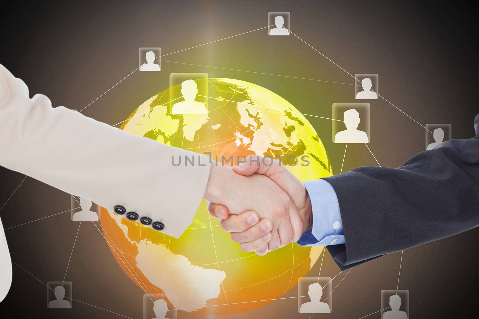 Smiling business people shaking hands while looking at the camera against global technology background