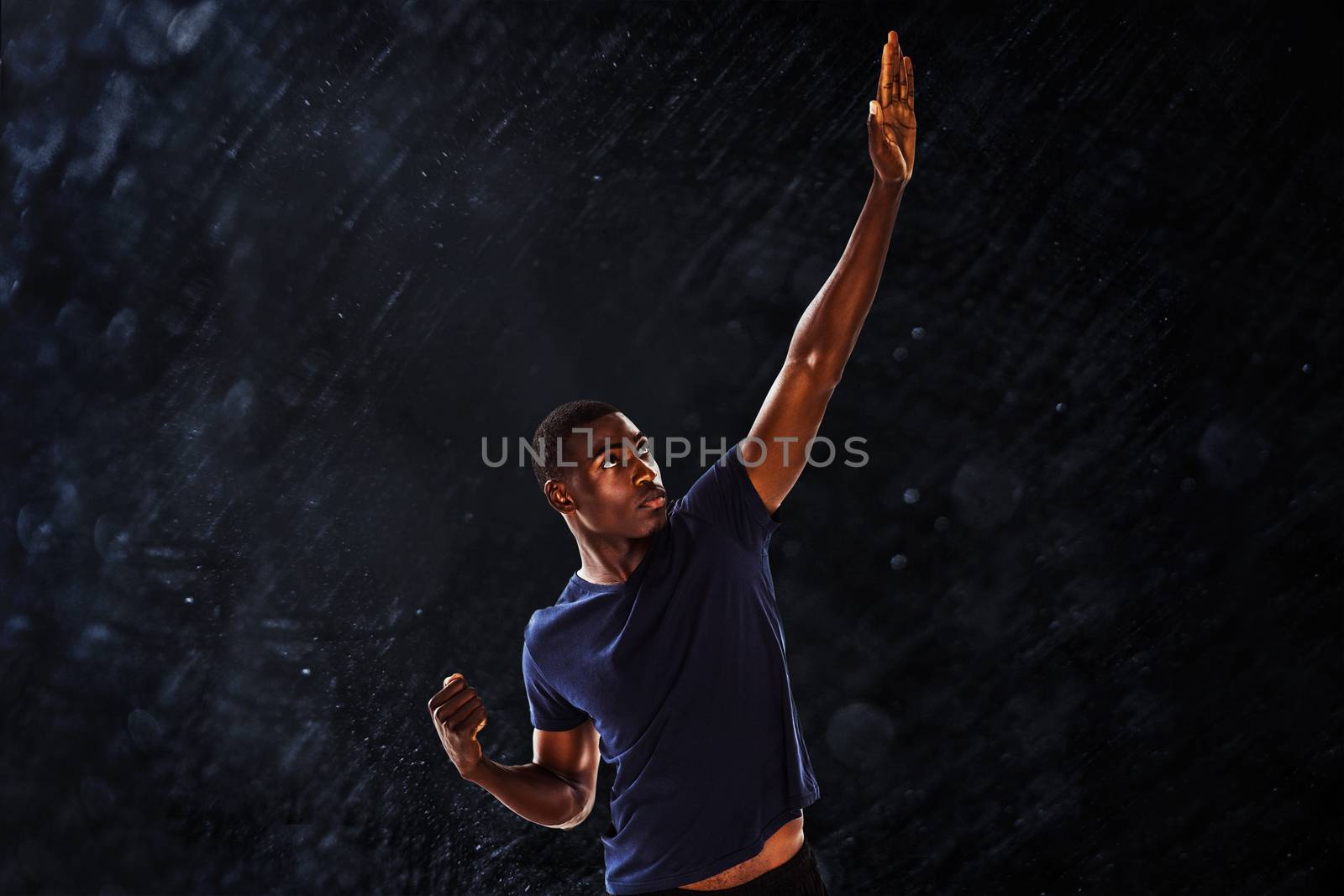 Serious young man with hand gestures against black background