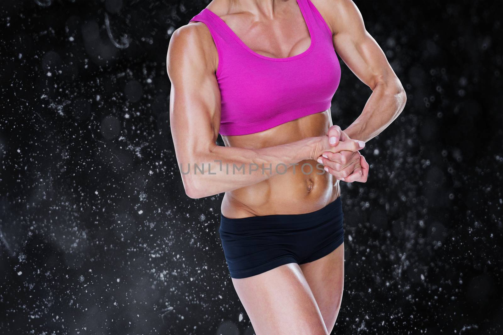 Composite image of female bodybuilder flexing in sports bra and shorts by Wavebreakmedia