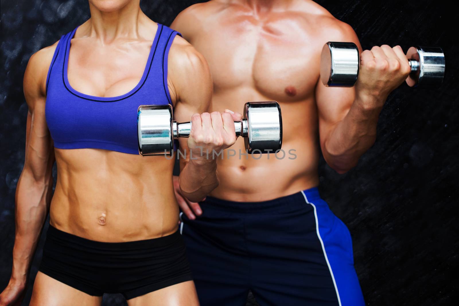 Bodybuilding couple against black background