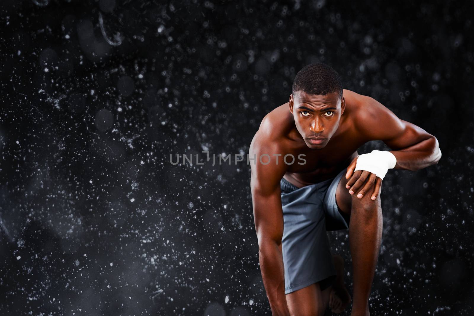 Fit muscular man against black background