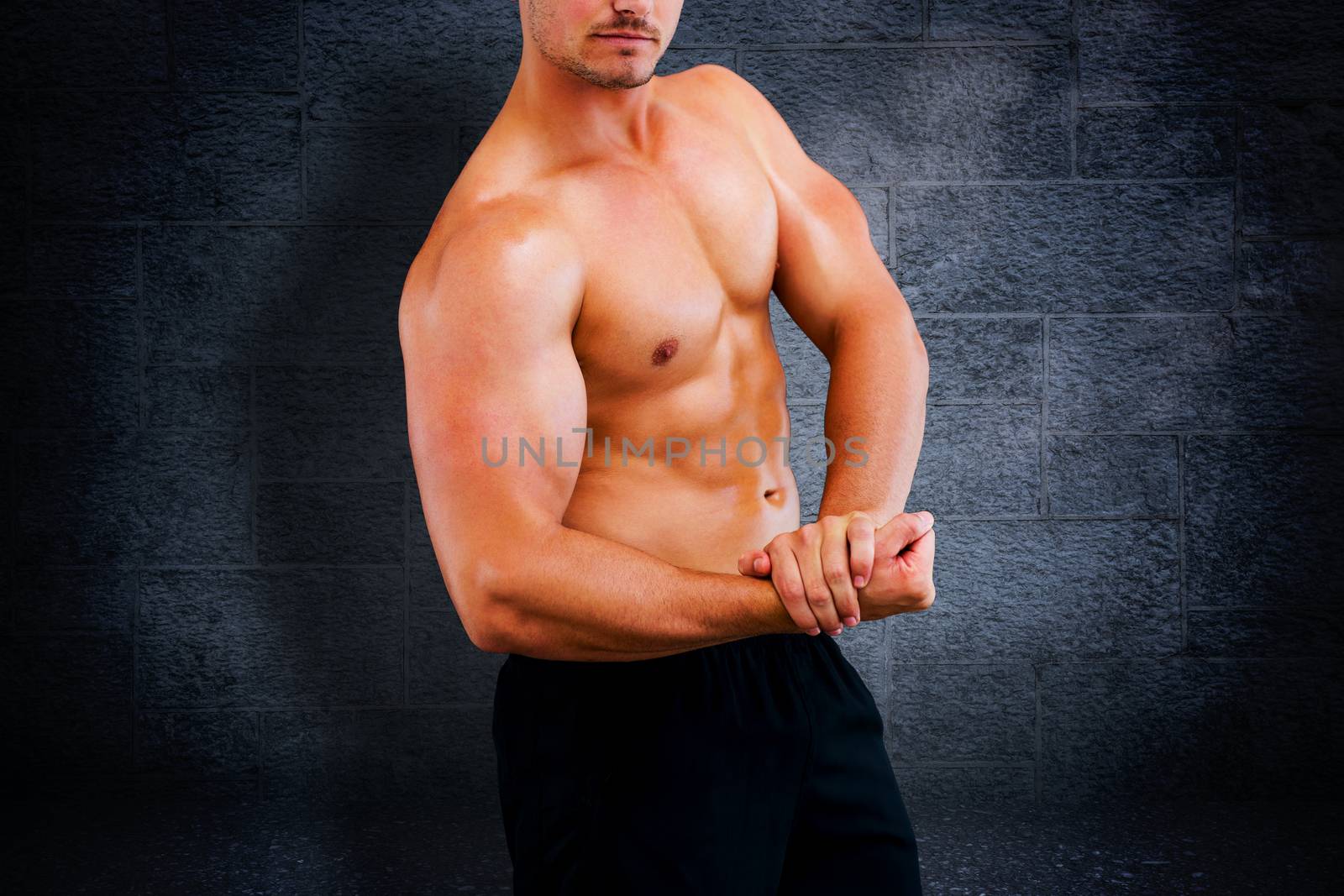 Bodybuilder  against black background