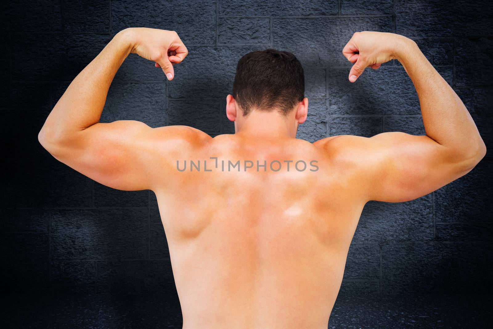 Attractive bodybuilder against black background