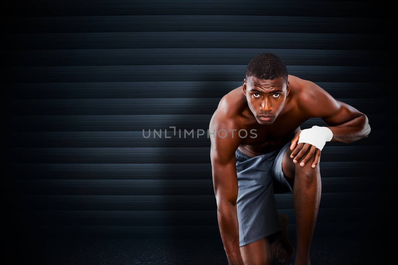 Fit muscular man against black background