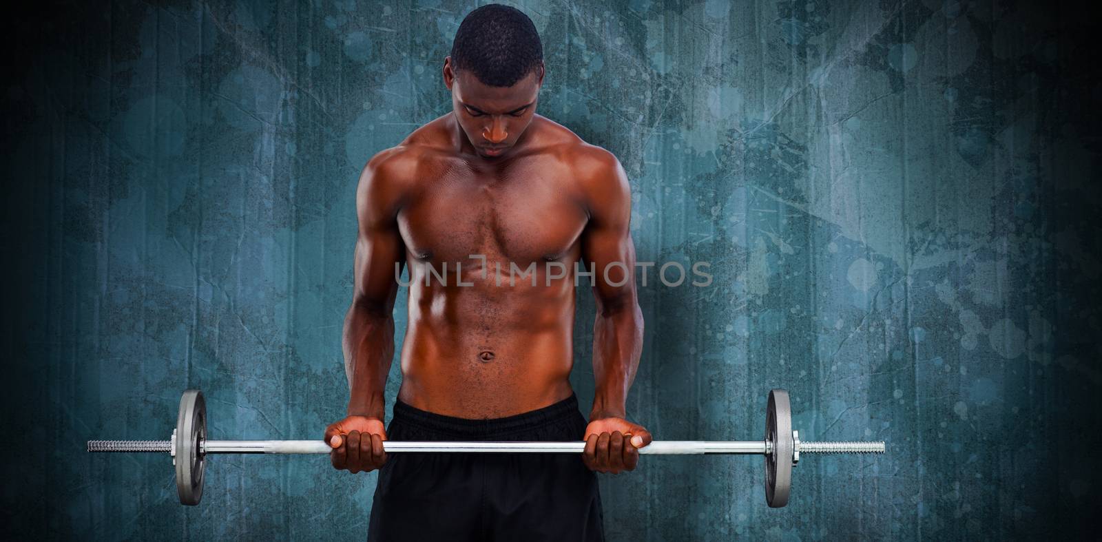 Fit man lifting barbell against blue paint splashed surface