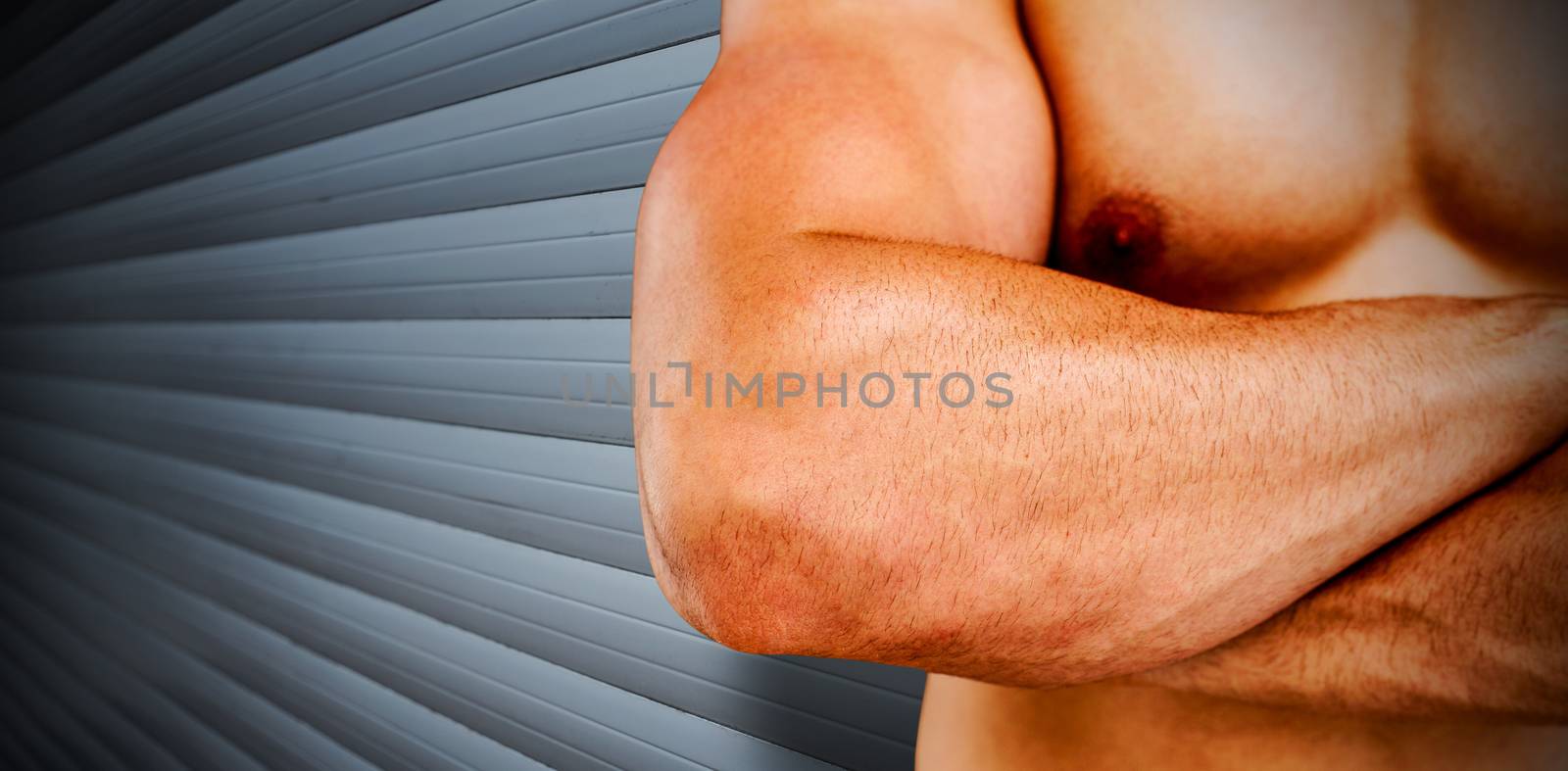 Bodybuilder  against grey shutters