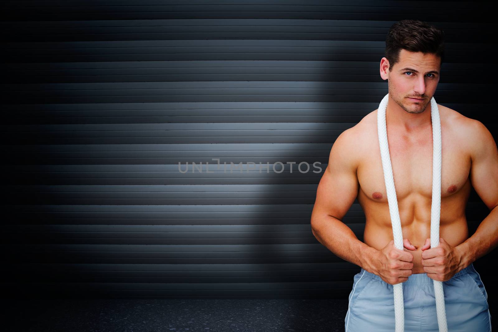 Handsome bodybuilder against black background