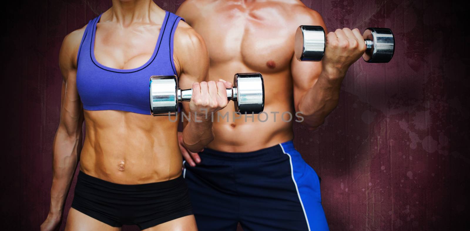 Bodybuilding couple against red paint splashed surface