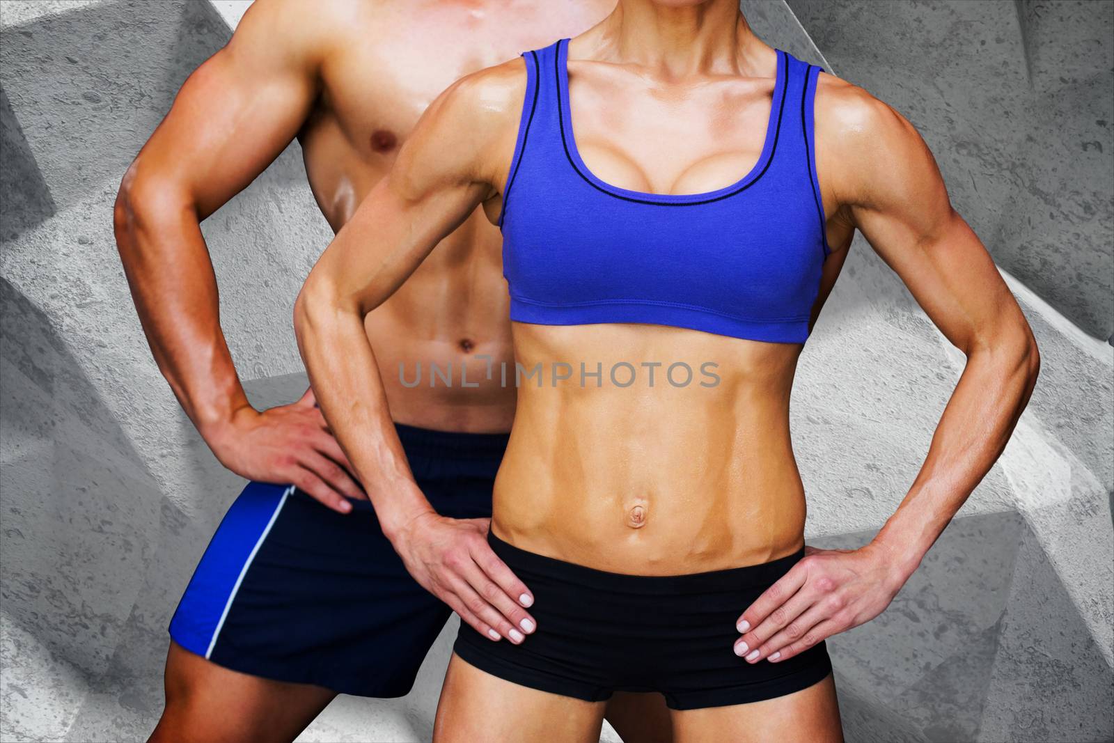 Bodybuilding couple against grey angular background