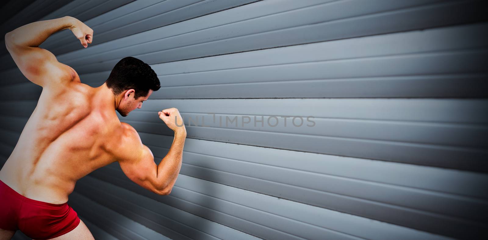 Attractive bodybuilder against grey shutters