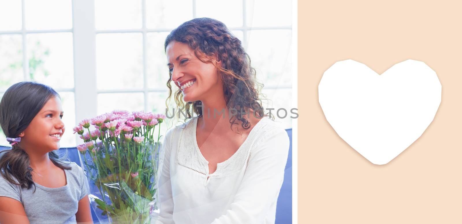 heart against happy mother and daughter sitting on the couch with flowers