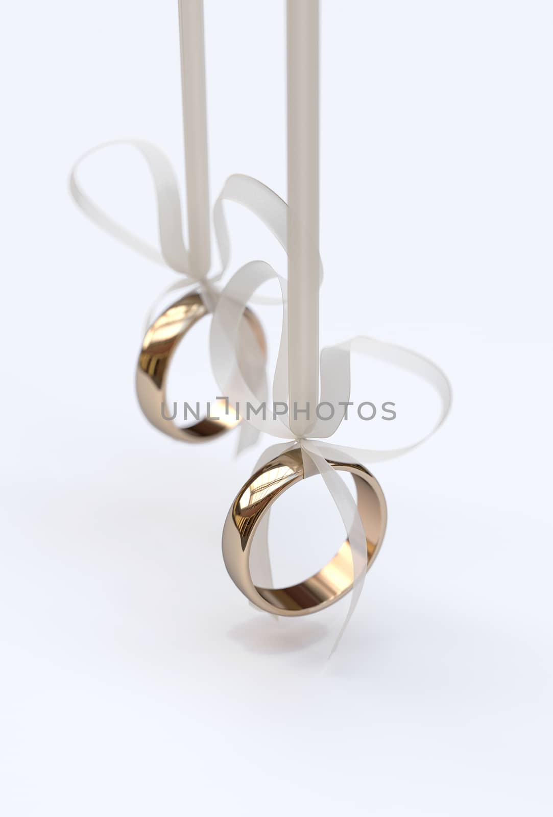 Couple of gold wedding rings with bows on white background
