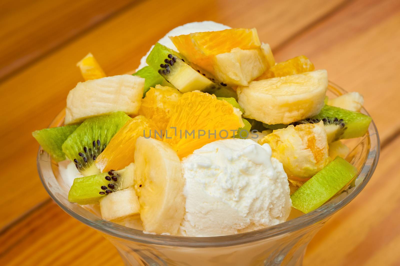 Orange, banana and kiwi fruit salad with icecream