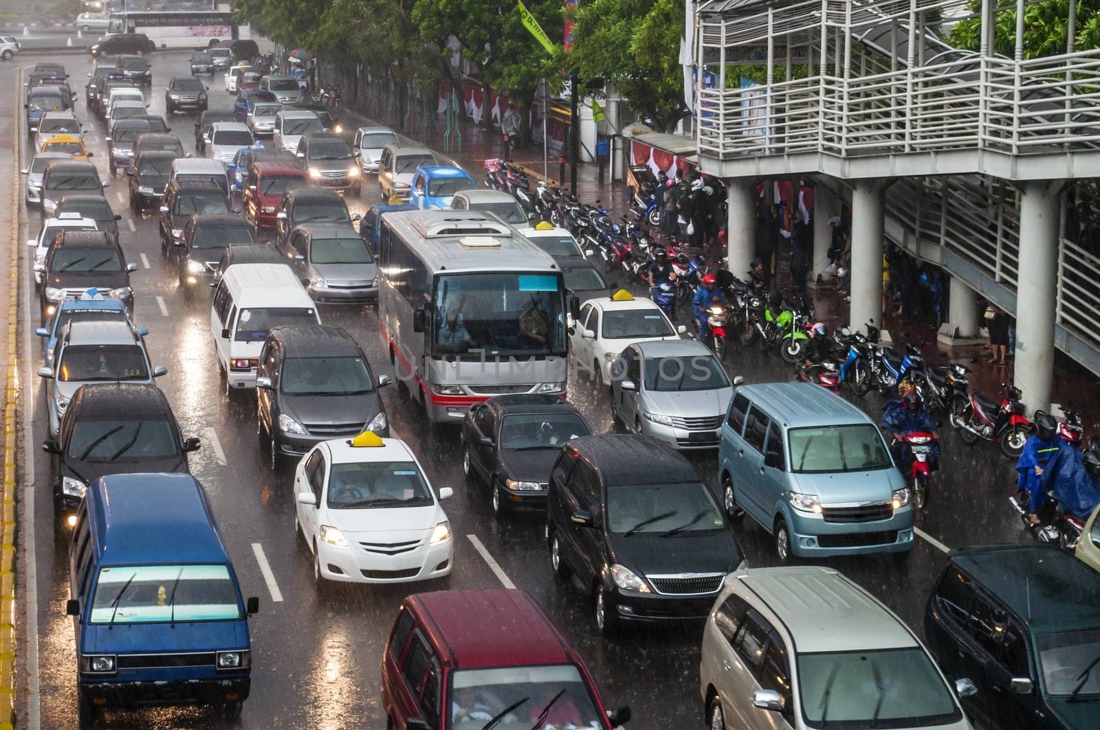 Crowded traffic jam in urban street in bad weather